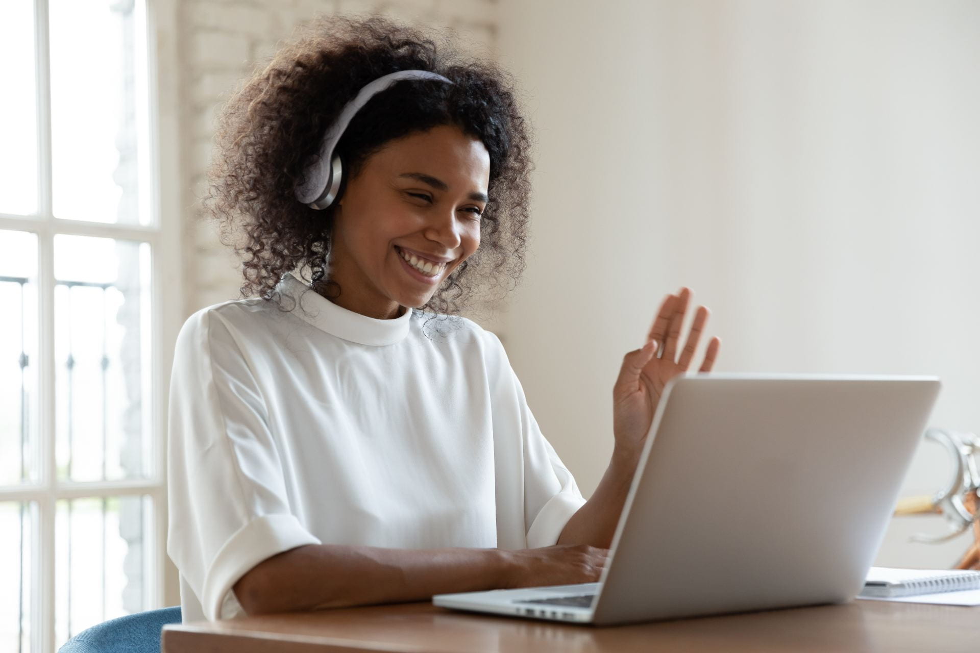 woman at a laptop wearing headphones