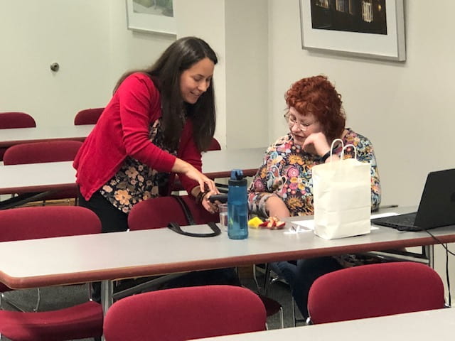 Image of Jessie Driver and Jodi Gill discussing a BlendLT plan while at a table.